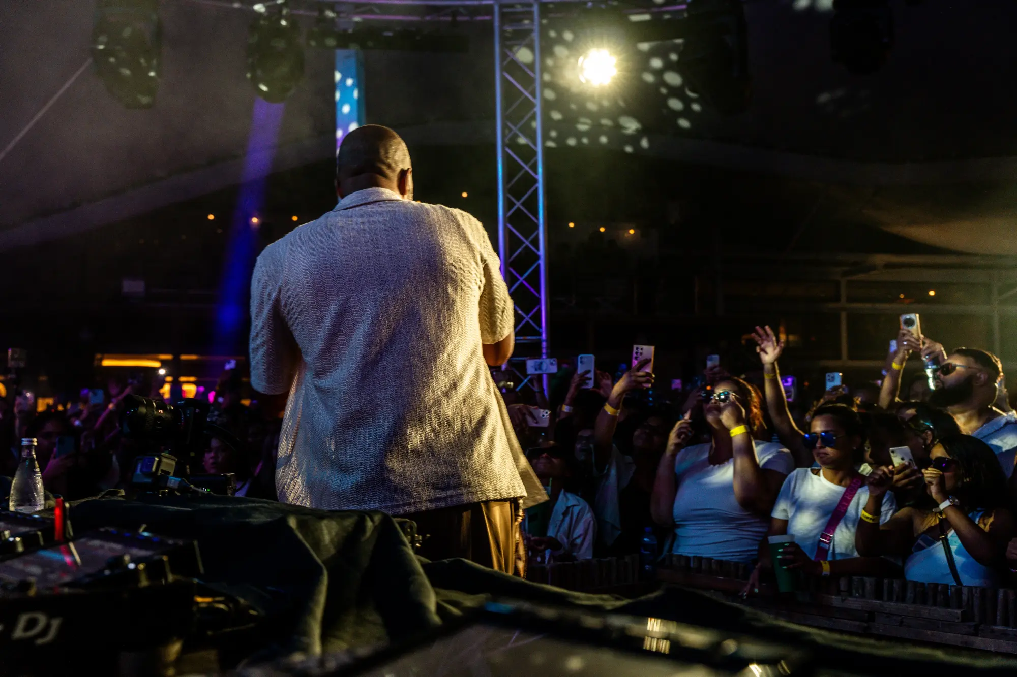 Surrender — the crowd with arms up under stage lights